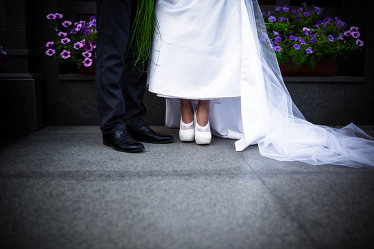 Photo of the legs of the bride and groom