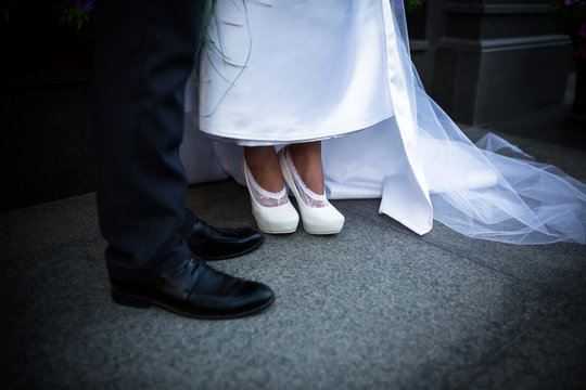 Photo of the legs of the bride and groom