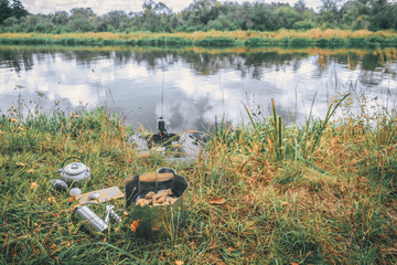 Prepare lunch on the river bank. Fishing from a boat.