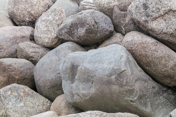 Retaining wall made of stones, boulders. Stone of volcanic rocks, granite, basalt, gabro. Bank protection on the sea beach. Protection of the coast from destruction by waves. Waterworks.