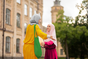 International muslim students smiling while meeting near university