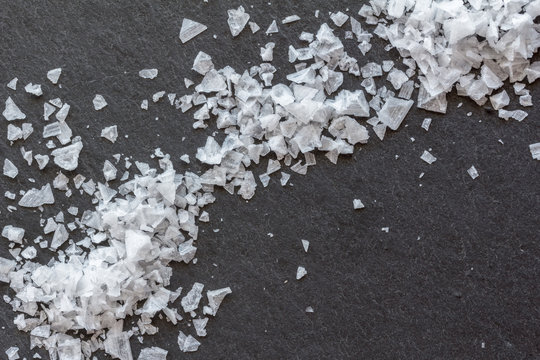 Cypriot sea salt flakes on black background - Overhead photo
