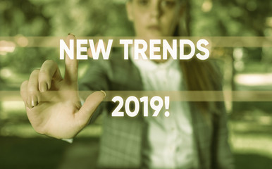 Word writing text New Trends 2019. Business photo showcasing general direction in which something is developing Business woman in the nature pointing with the finger into empty space