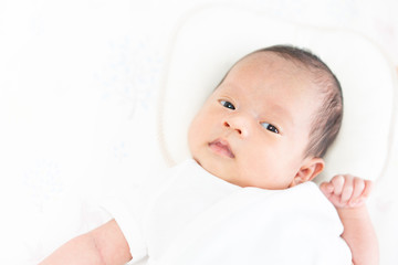 Baby lying on the crib