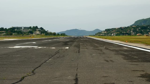 Passenger aircraft flying in the sky. Airplane landing on the runway at airport. Greece. 4K