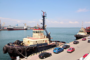 Views of container and cargo berths with sea vessels, tugs and yachts. Port Odessa, Ukraine. Summer 2019.
