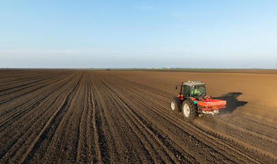 Farmer fertilizing arable land