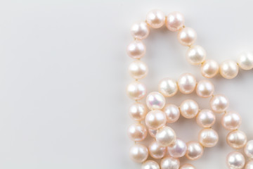 Pearl necklace with real pink pearls isolated on white background - top view photo