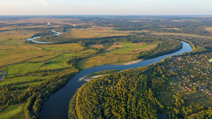 Aerial view of river flood. Beautiful flooded meadow. Flying above beautiful Desna river when the river is full of water at spring at National Nature Park in Chernihiv Oblast, Ukraine.