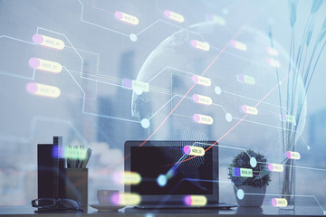 Double exposure of desktop with computer and world map hologram. International data network concept.