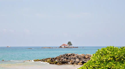  Beautiful beach with palm trees and boulders on the tropical island of Sri Lanka. 