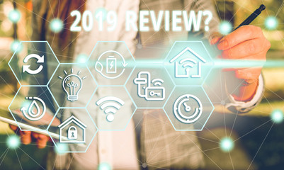 Word writing text 2019 Review Question. Business photo showcasing remembering past year events main actions or good shows Female human wear formal work suit presenting presentation use smart device