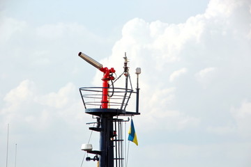 Cranes and masts against the blue sky.