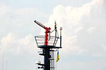 Cranes and masts against the blue sky.