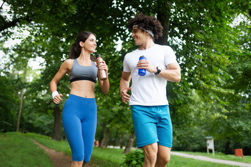 Beautiful couple jogging in nature living healthy