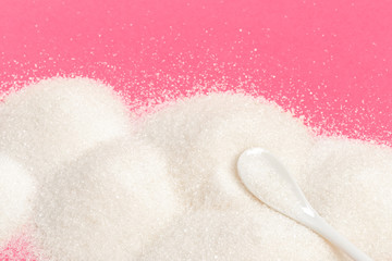 Heaps of sugar on pastel background
