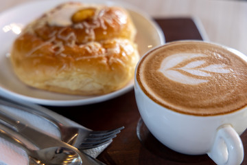 Filipino traditional desert Ensaymada with cafe latte