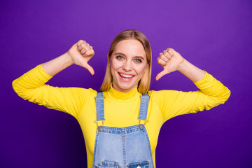 Portrait of lovely youth pointing at herself wearing yellow turtleneck denim jeans overalls...