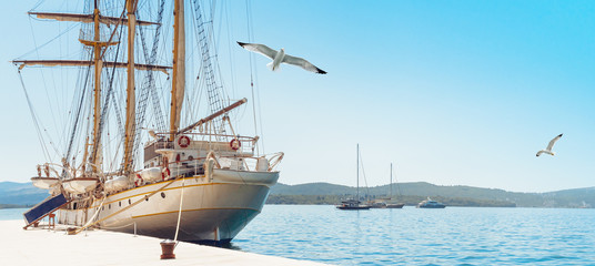 Fototapeta na wymiar Coastline of Montenegro with sailing ships in Tivat bay.