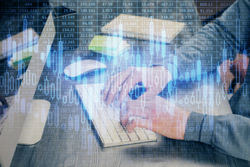 Stock graph with businessman typing on computer in office on background. Concept of analysis....