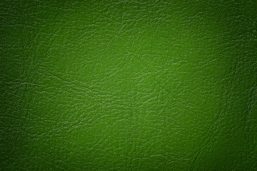 Dark green leather texture background, closeup. Emerald cracked backdrop