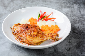 Hot and spicy baked chicken on white plate