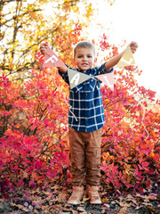 Greeting autumn garland in kid's hands.