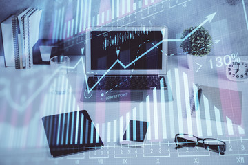 Forex market graph hologram and personal computer on background. Multi exposure. Concept of investment.