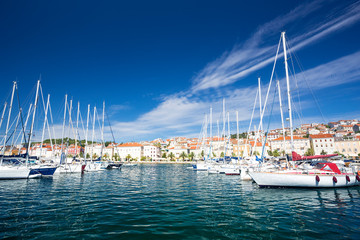 yachts moored at the pier in harbour of Losinj town, Croatia.