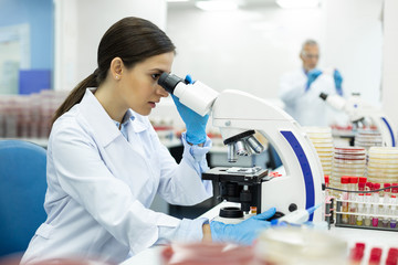 Attentive brunette female person doing blood analysis