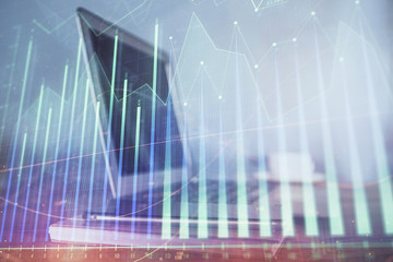 Stock market graph and table with computer background. Double exposure. Concept of financial analysis.
