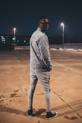 portrait of young black man posing and showing his back