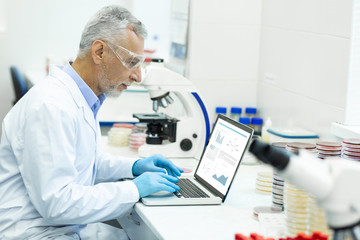 Attentive male person working at his experiment