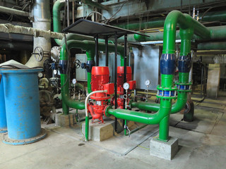 Industrial big water pumps with electric motors, pipes, tubes, equipment and steam turbine at power plant