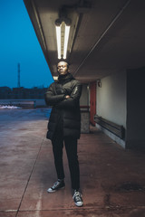 young black man looking camera and posing outdoor
