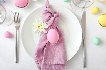 Table setting for Easter celebration on white background