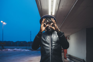 portrait of young black man standing outdoor showing hands