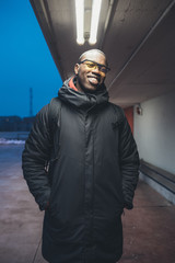 young black man looking camera and posing outdoor