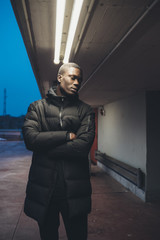 young black man looking camera and posing outdoor