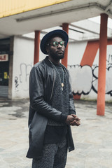 young african man standing in the street and looking camera