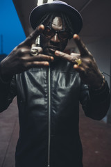young  african bearded man outdoors posing looking camera