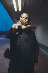 young black man looking camera and posing outdoor
