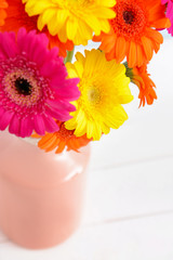 Vase with beautiful gerbera flowers on table