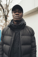 portrait of young african man standing in the street
