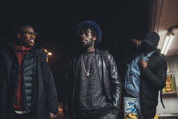 Three young african men walking in the street together