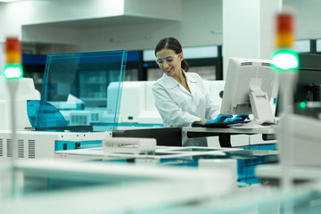 Cheerful medical worker testing new computer program