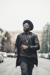 young bearded african man outdoors walking looking away