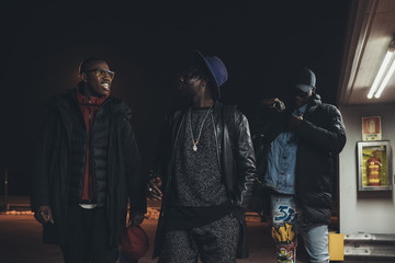Three young african men walking in the street together