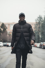 young bearded african man outdoors walking looking camera