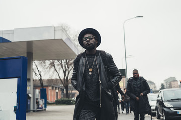 young black man walking in the street and looking further